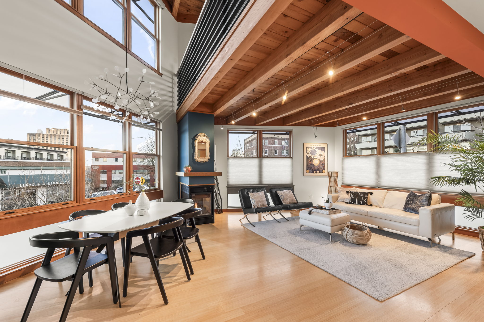 Beautifully staged living and dining area in a Tacoma listing with exposed wood beams and city views